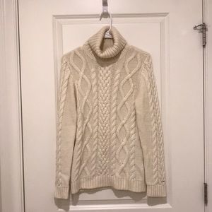 Cream turtleneck sweater.